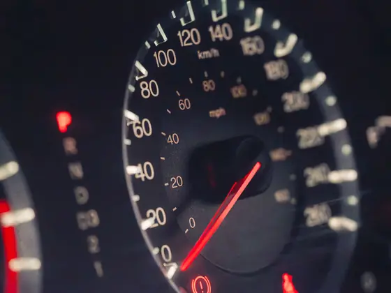 Close view of a vehicle speedometer in low light