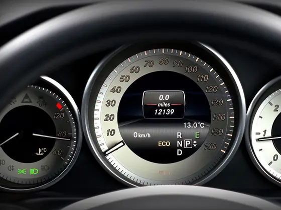 Close view of a car dashboard showing speedometer and odometer