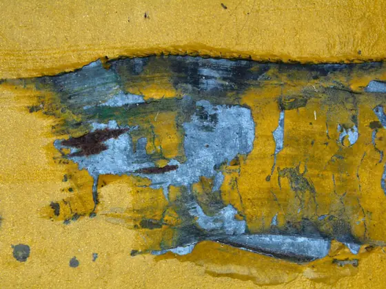Close view of weathered painted metal showing age and texture