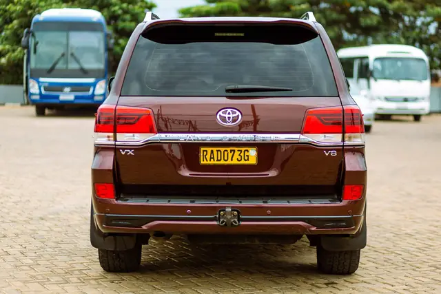 Rear view of a dark red Toyota Land Cruiser SUV parked in a lot